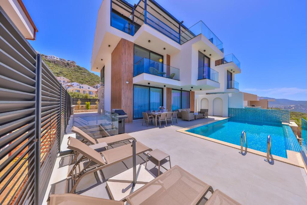 a villa with a swimming pool and a house at Villa Sky Line - Private Pool - Panoramic Sea View in Kaş