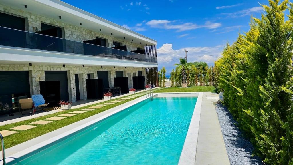 a swimming pool in front of a house at Linen Sea Halkidiki in Kriopigi