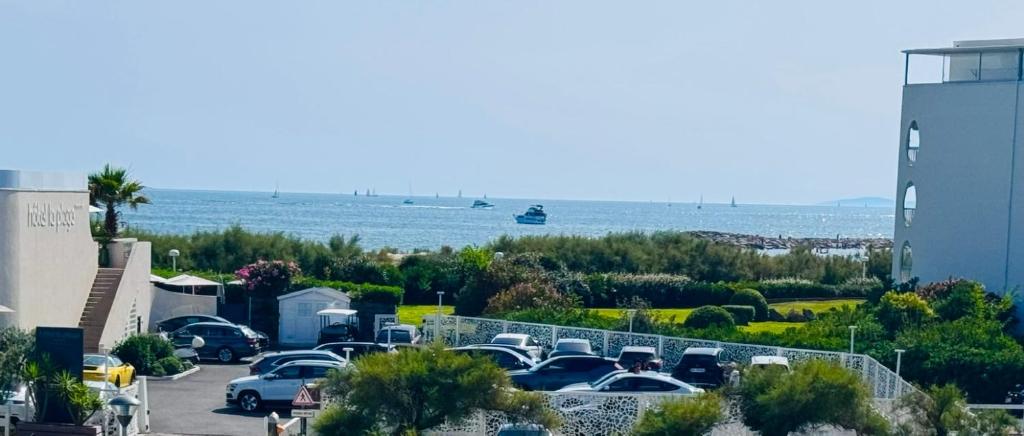 a parking lot with cars parked next to the water at Studio front de mer 'Le Soleillan' in La Grande Motte