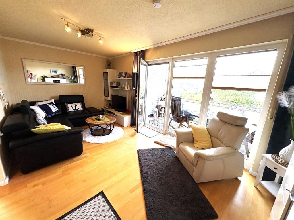 a living room with a couch and a chair at Ostseeliebe in Grömitz