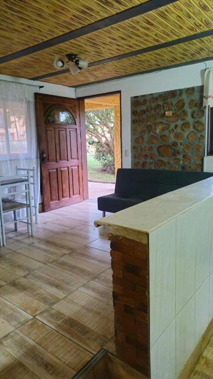 a living room with a couch and a table and a door at Natural country house in Guarne