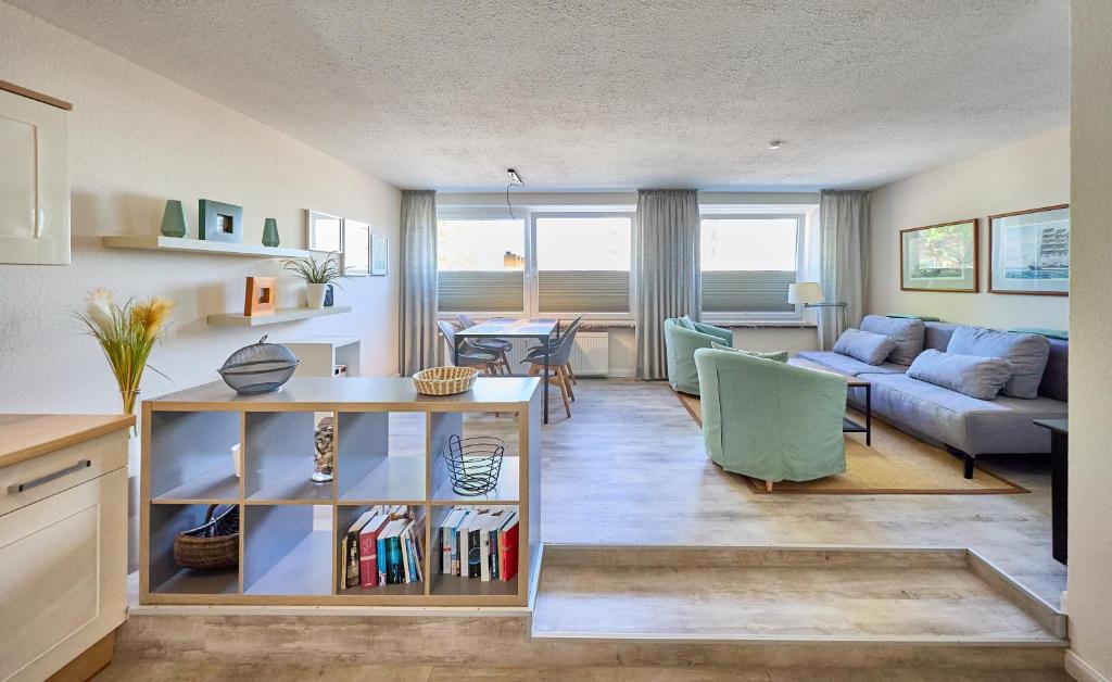 a living room with a couch and a table at Haus Schildt, FeWo 8 in Duhnen