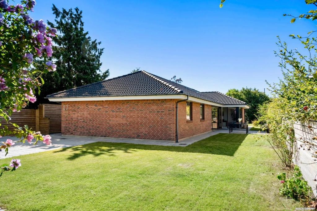 a brick house with a lawn in front of it at Spacious Luxury Villa in Copenhagen in Copenhagen