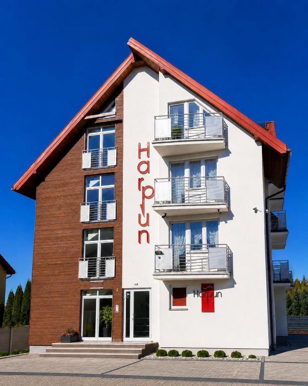 a building with a red sign on it at Harpun in Władysławowo