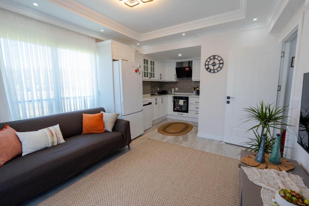 a living room with a couch and a kitchen at Luna in Dalaman