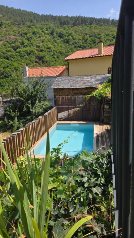 a swimming pool in a yard with a fence at Varanda do Brejo in Seia