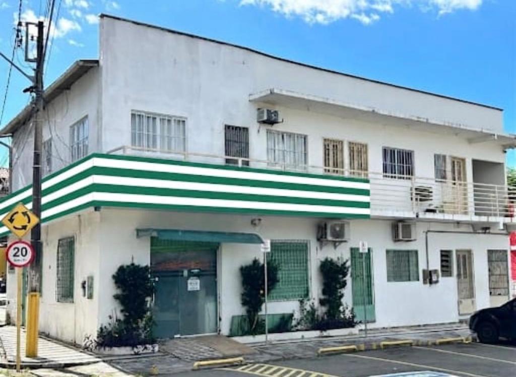 a white building with green and white stripes on it at Betesda 2197F in São Luís