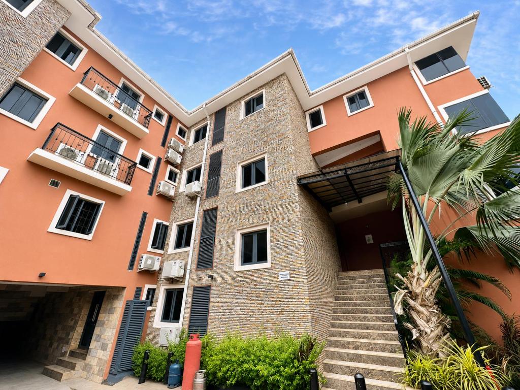 an apartment building with stairs in front of it at Fadars Place in Sagisa