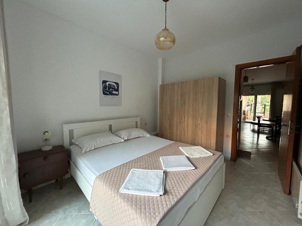 a bedroom with a bed with two books on it at Evgenias Beach Escape in Kallithea Halkidikis