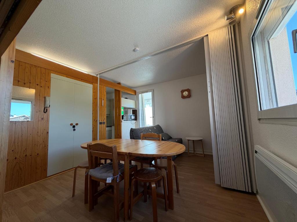 a dining room with a table and chairs and a window at Parenthèse nature à Prémanon in Prémanon