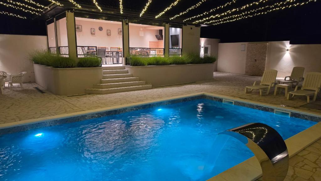 a swimming pool with blue water in a building at Villa Aida in Sarajevo