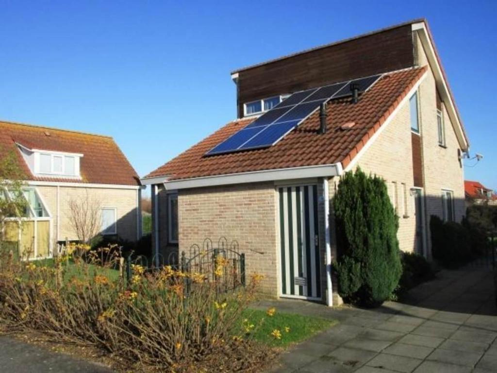 a house with a solar panel on the roof at Bungalow in Breskens near Beach and Pool in Breskens