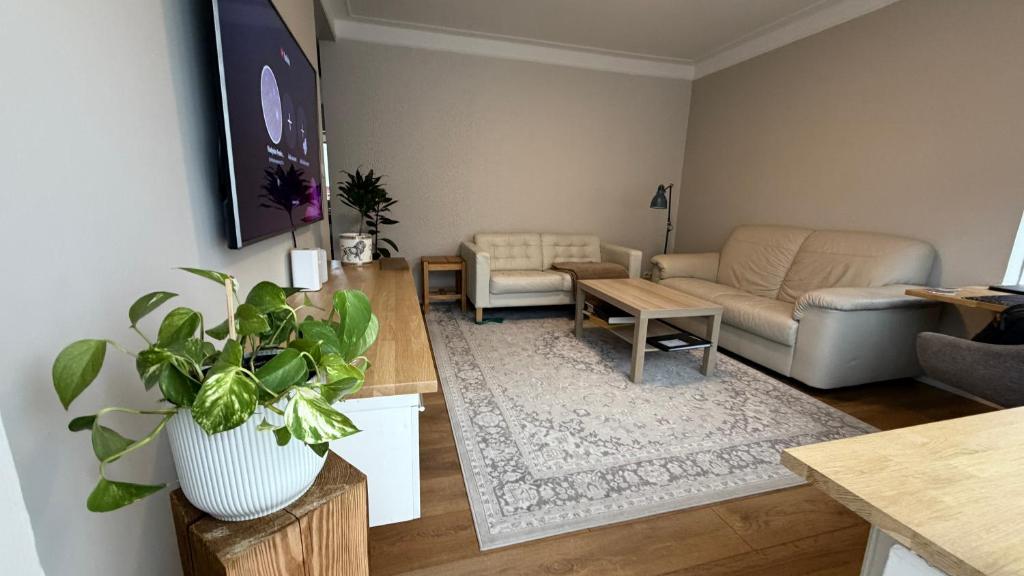 a living room with a couch and a table at Keflavik Heart in Keflavík