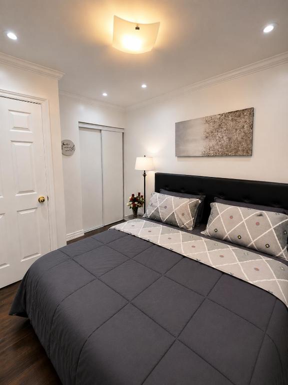 a bedroom with a large black bed in a room at The Quiet Nest in Mississauga