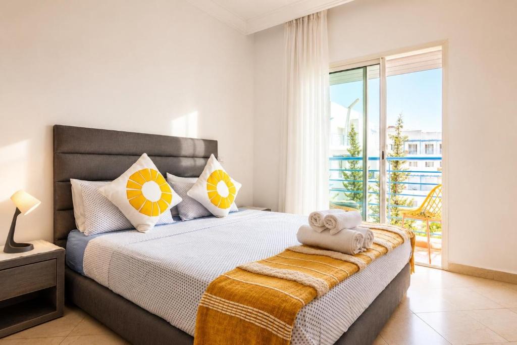 a bedroom with a large bed with a balcony at Brisa Marina Cabo in Cabo Negro