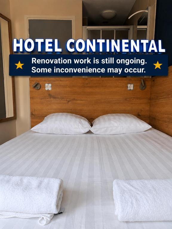 a bed with two pillows in a hotel room at Hotel Continental Amsterdam in Amsterdam