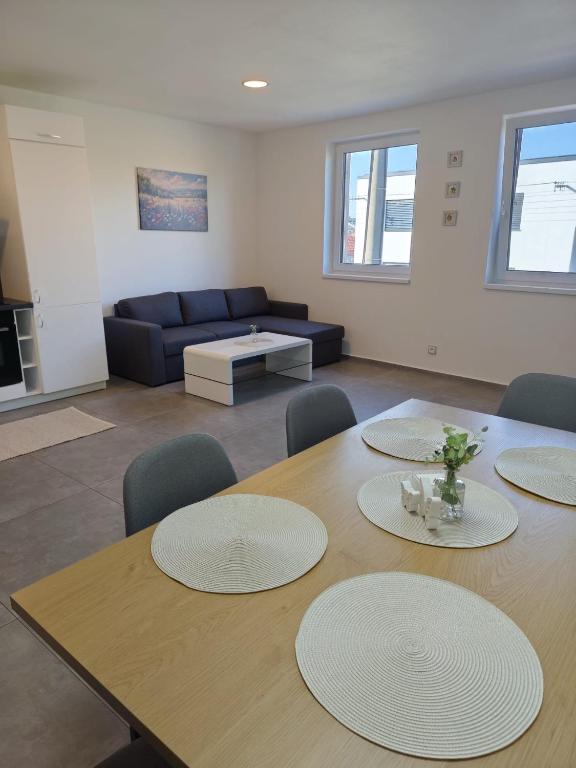 a room with a table and chairs and a couch at Apartmán na Břehách in Veselí nad Moravou