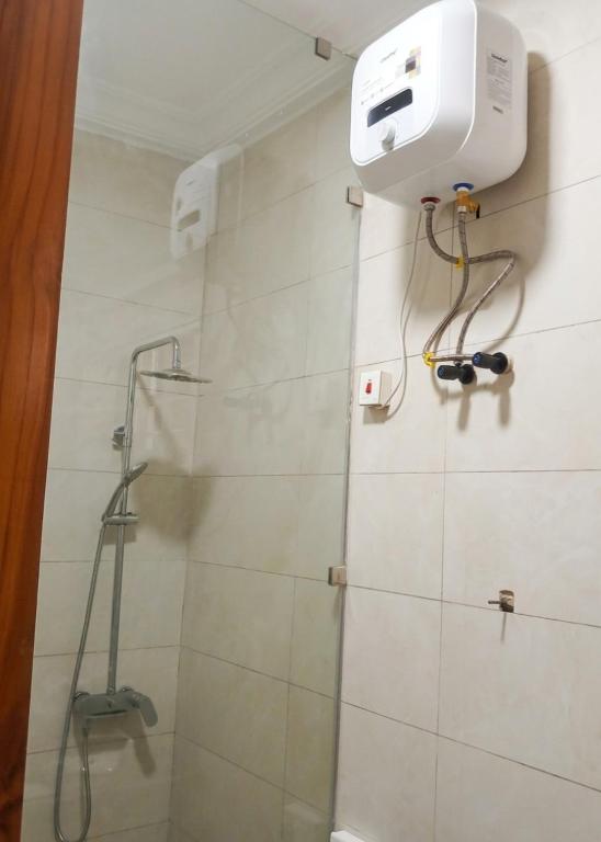 a bathroom with a shower with a shower head at The Crest at Oyarifa in Oyarifa
