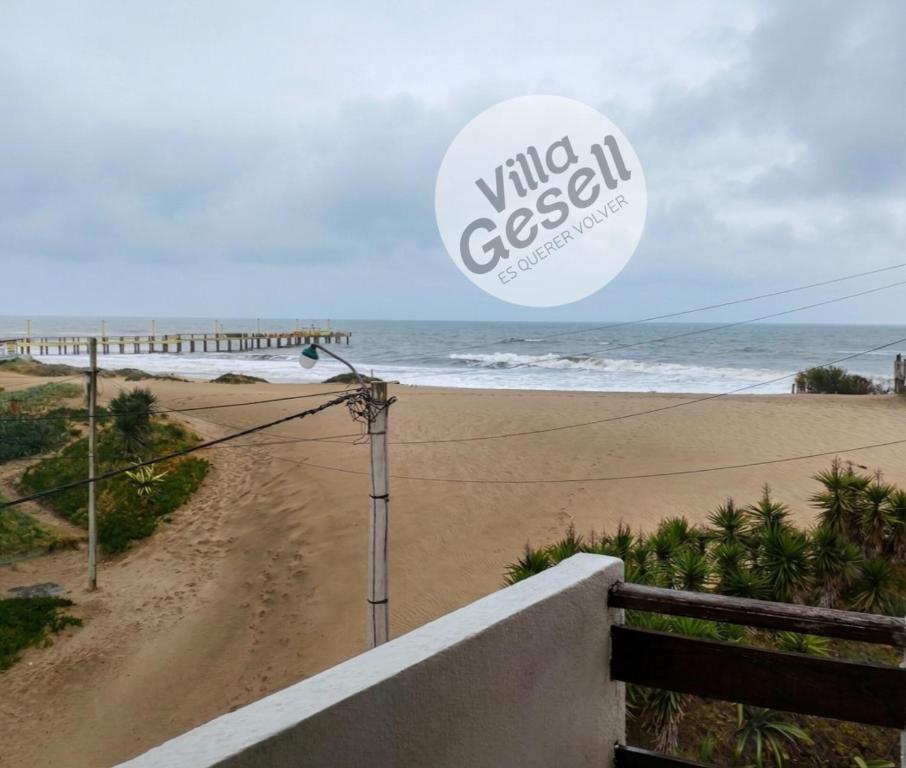 a beach with a sign that reads wine cisco at Bright beachfront apartment with ocean view in Villa Gesell