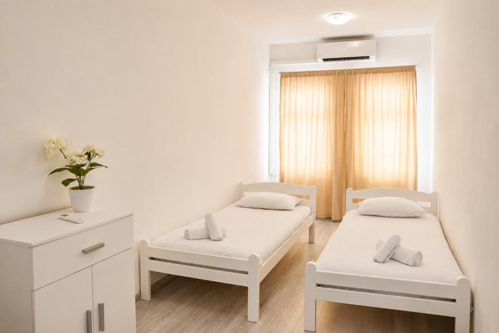 a hospital room with two beds and a window at Apartman San in Mostar