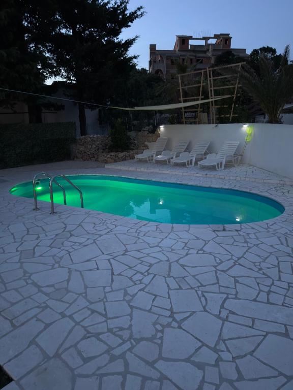 a swimming pool in a yard at night at Villa Adria in Novalja