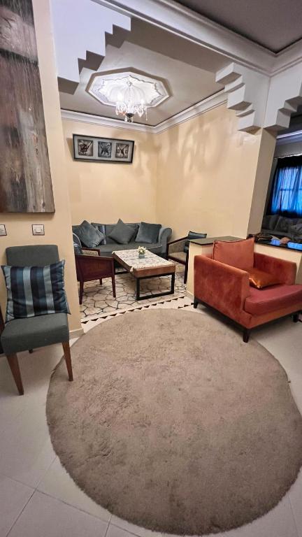 a living room with couches and a table at Honey house in Marrakesh