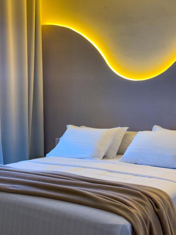 a bedroom with two beds with white pillows at My Way Flat in Aracati