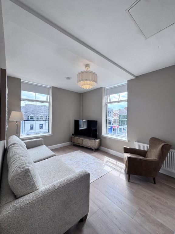a living room with a couch and a tv at Studio 4 in Portadown