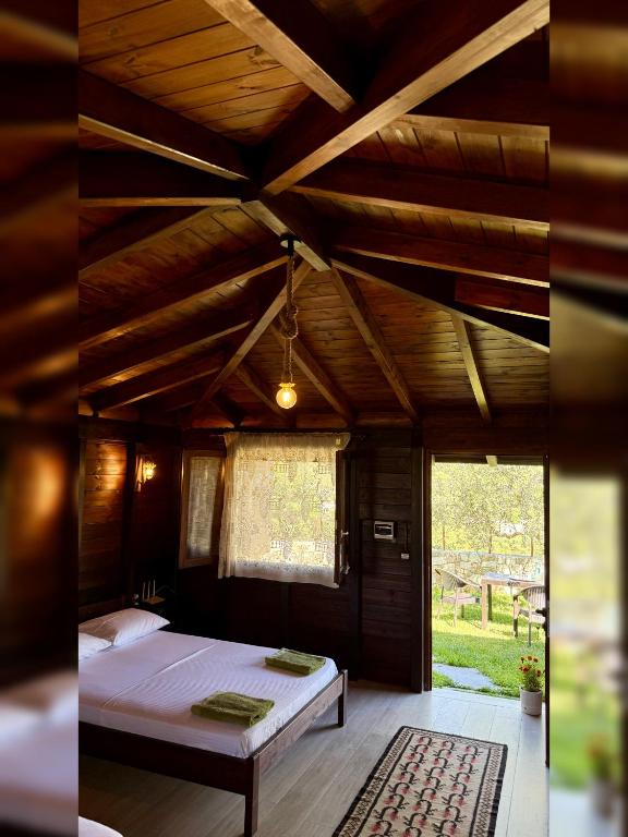 a bedroom with a bed and a wooden ceiling at Guest House Gorani in Berat