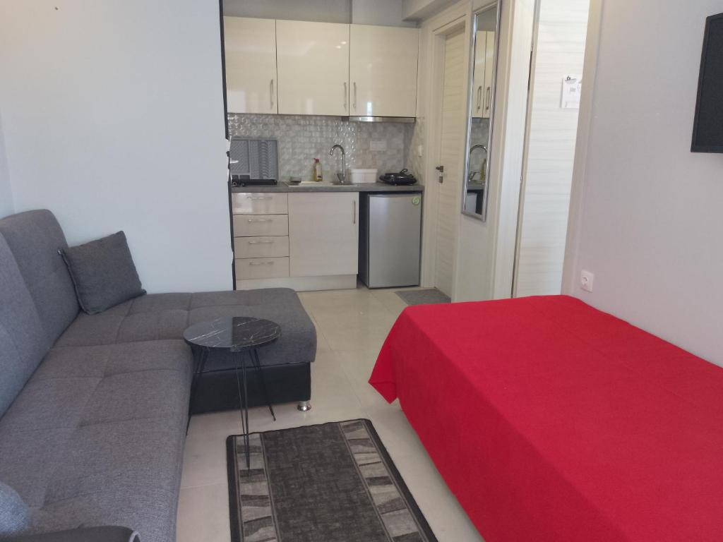 a living room with a couch and a red table at Lana in Paralia Katerinis