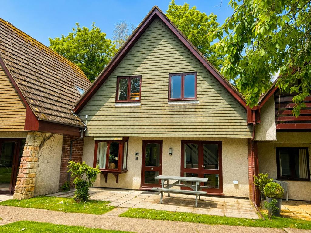 a house with a picnic table in front of it at 47 Trevithick Court in Hayle