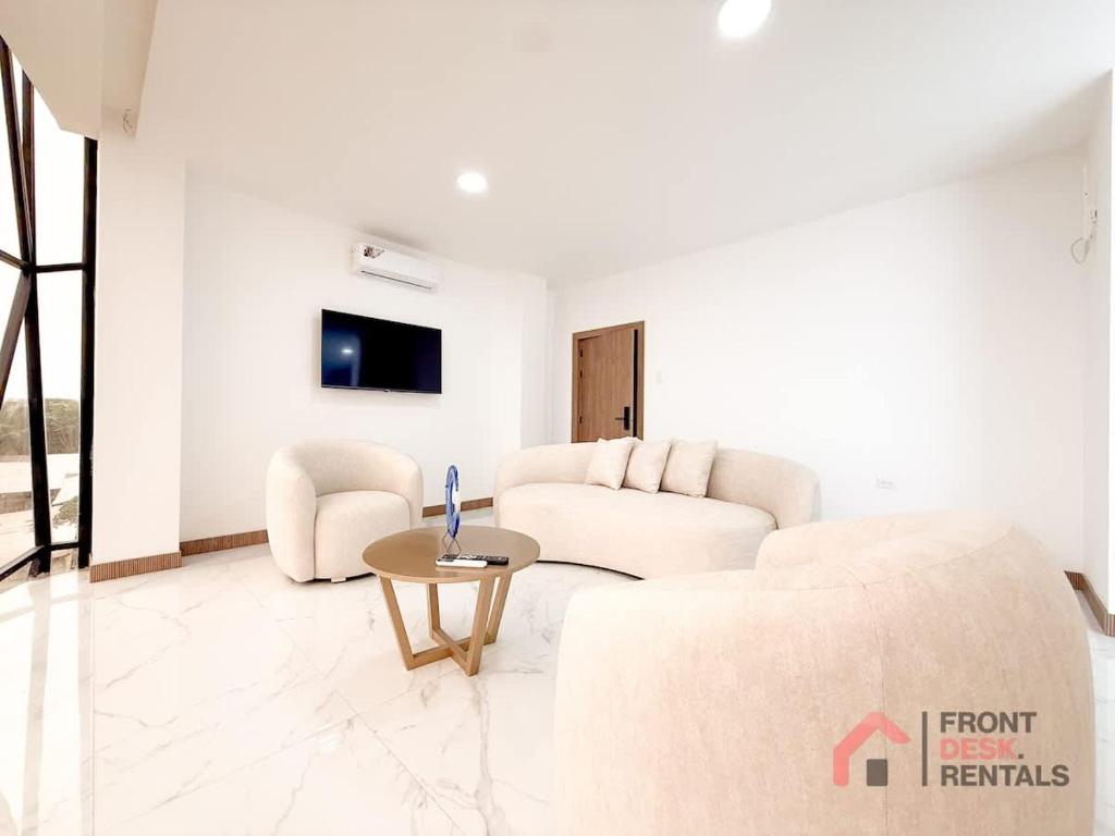 a living room with a couch and a table at Beachfront Escape Pool Hot Tub and Fire pit in Montañita