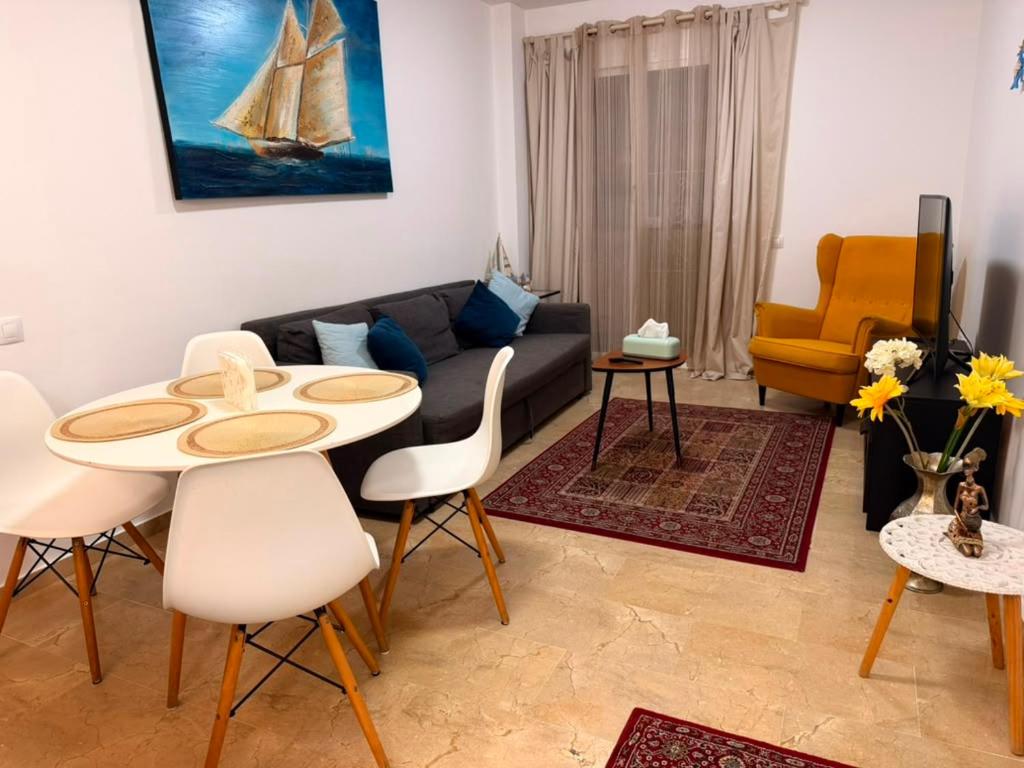 a living room with a couch and a table and chairs at Casaberian Manilva Beach Estepona, Marbella, Malaga, SPAIN in Manilva