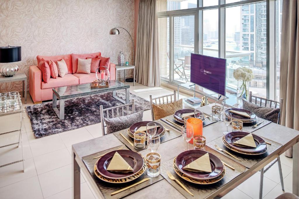 a living room with a table and a couch at Dream Inn Apartments - Park Island in Dubai
