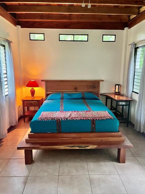 a bedroom with a bed in a room with windows at Kliffstone Jungle House in Sayab Camp