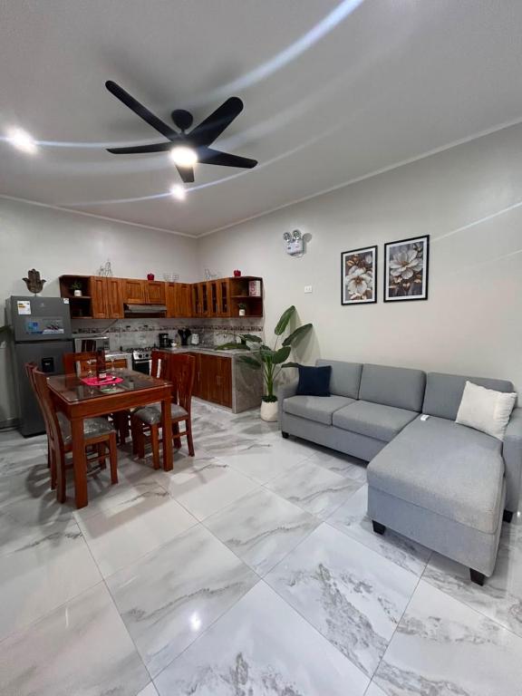 a living room with a couch and a ceiling fan at casa sol de sauce in Sauce
