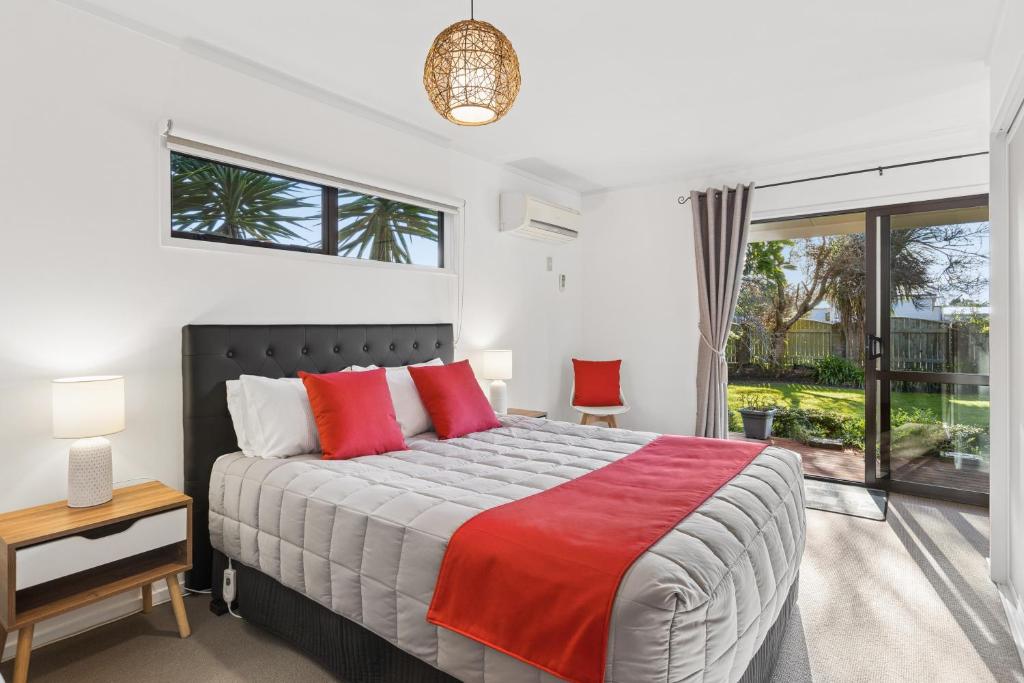 a bedroom with a large bed with red pillows at Modern-Immaculate-Spacious-Comfy Beds-Private in Westport