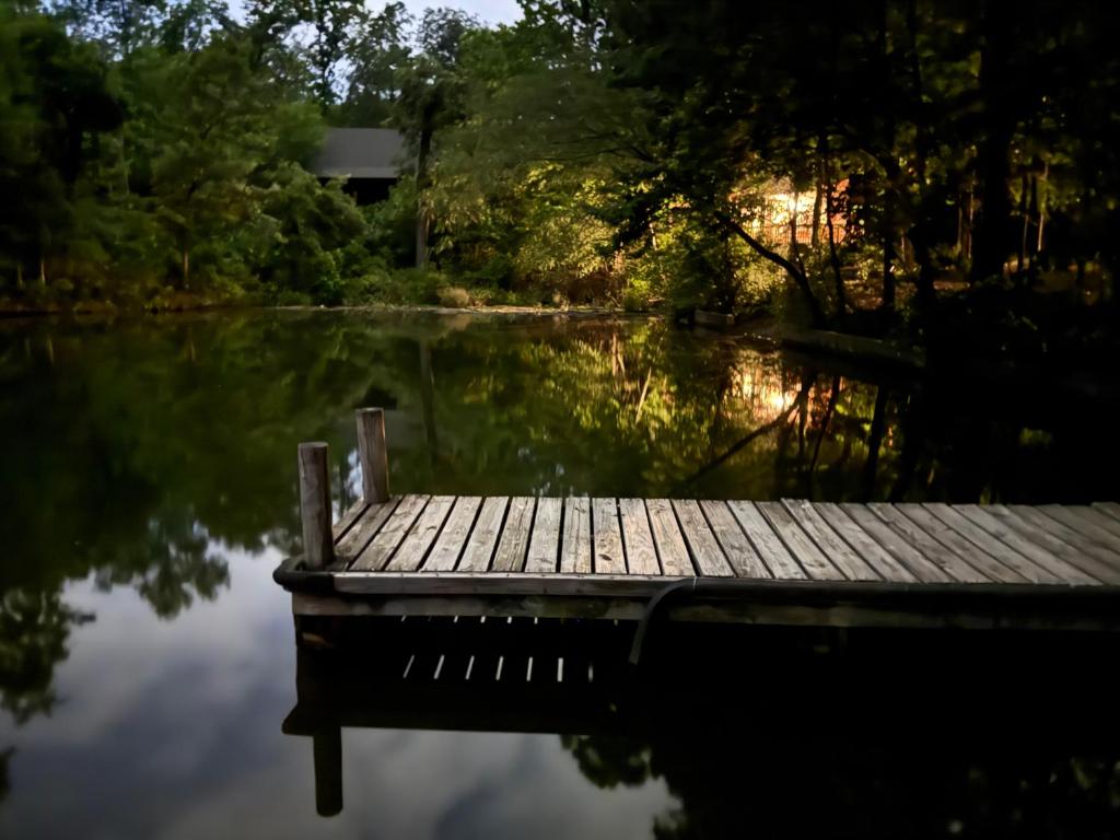 a dock on a body of water at E-HOT SPRINGS MYSTIQUE - Historic Five Points Lake Hamilton in Hot Springs