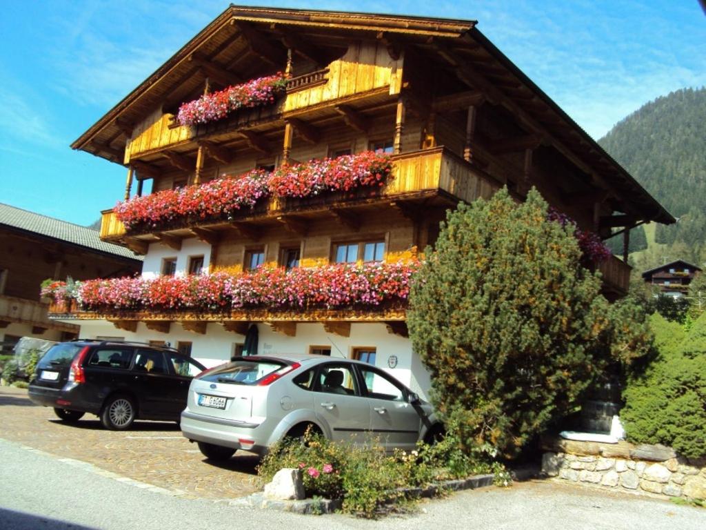 a building with flowers on the side of it at Haus Postfeld in Alpbach