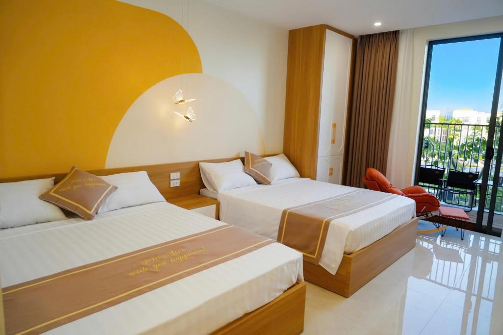 a hotel room with two beds and a balcony at Homestay The Pathway Sầm Sơn in Sầm Sơn