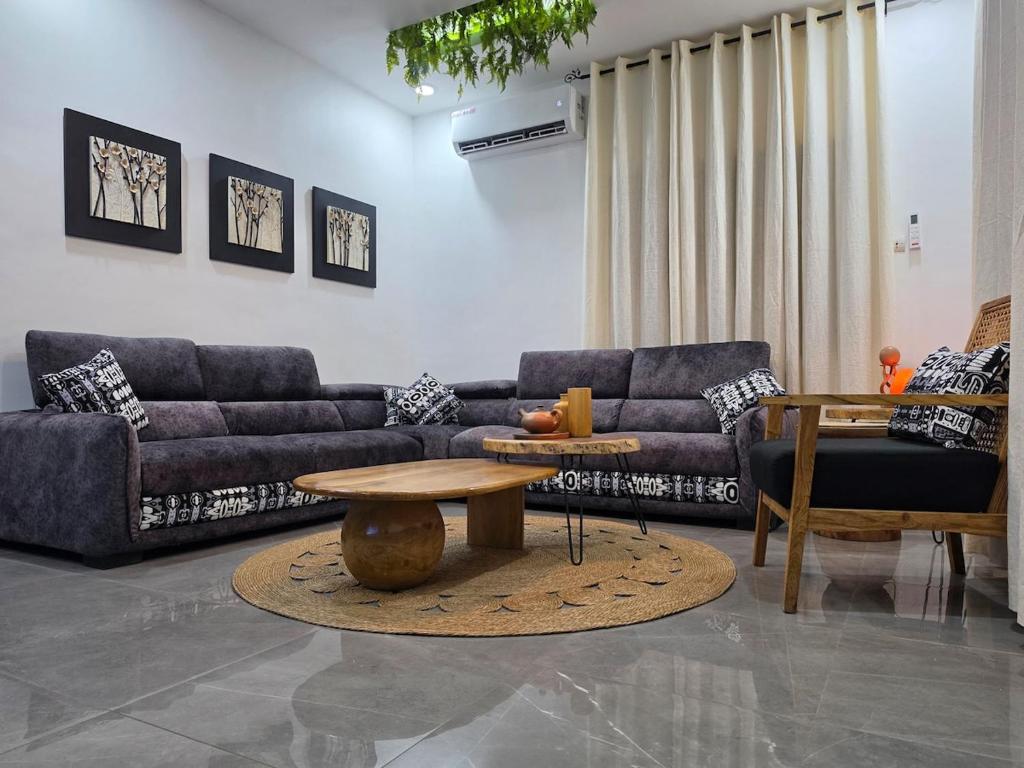 a living room with couches and a coffee table at Little Heaven Villa in Lomé