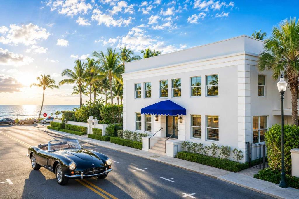 an old car parked in front of a white building at The Palm Beach House - Tropical in Palm Beach