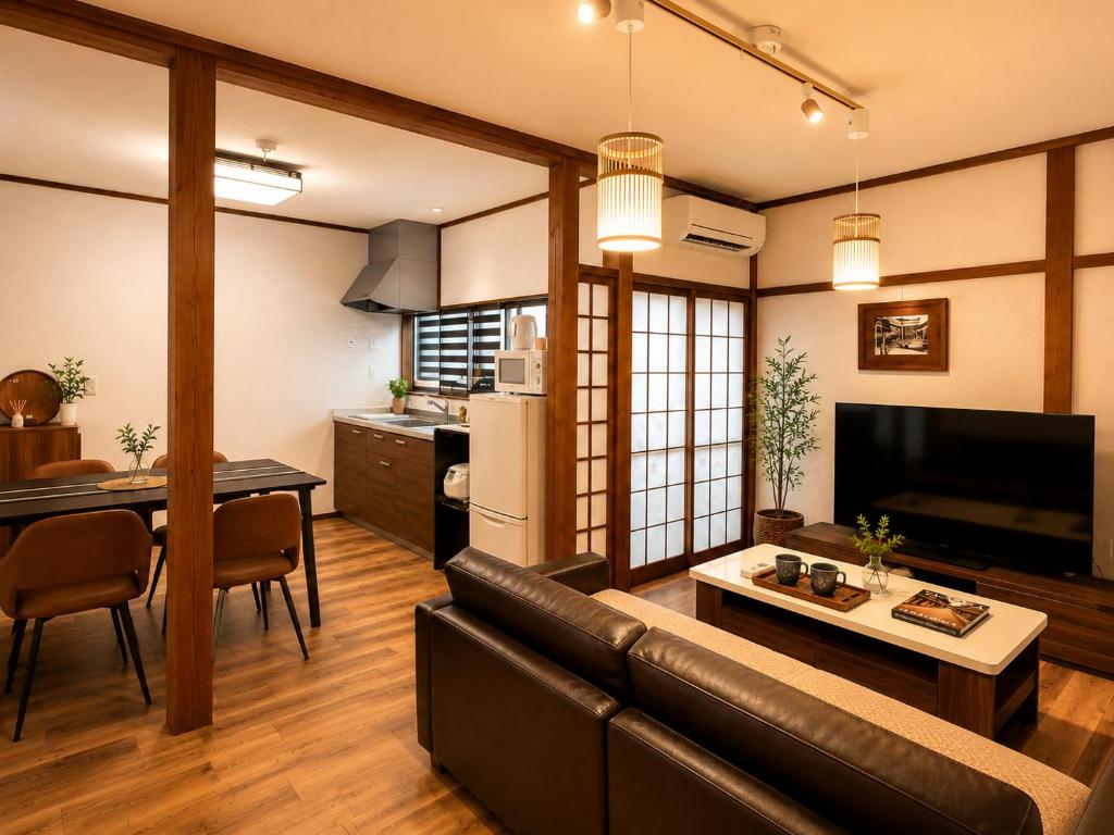 a living room with a couch and a table at Private House HidaTakayama - Cozy Family Home in Takayama