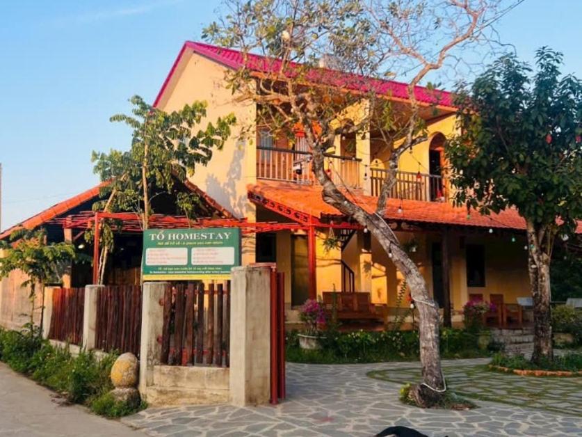 a building with a sign in front of it at Cat Tien Riverside Lodge in Tân Phú