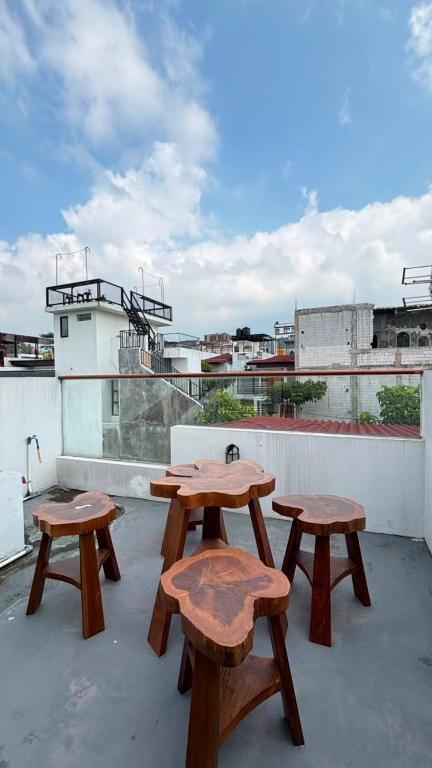 three wooden benches sitting on top of a roof at Villa Alibaba E5 in Tlekung