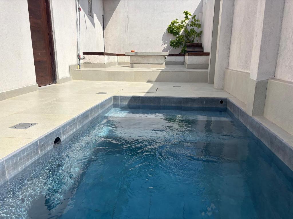 a swimming pool with blue water in a building at Mulberry Villa in Anuradhapura