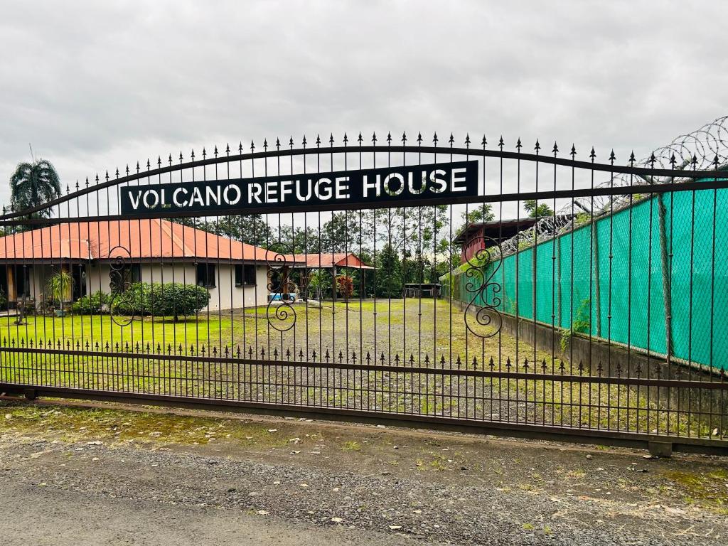a fence with a sign that reads yaho residence house at Volcano Refuge House in Fortuna