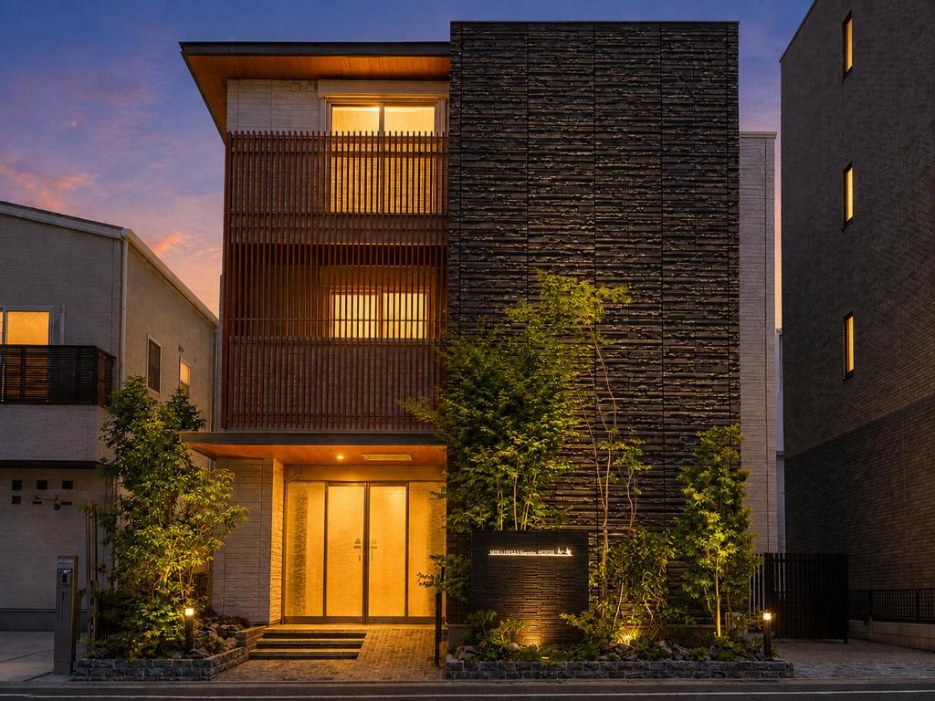 a tall brick building with lights on it at KURASHIKI Station HOTEL 和奏 in Kurashiki