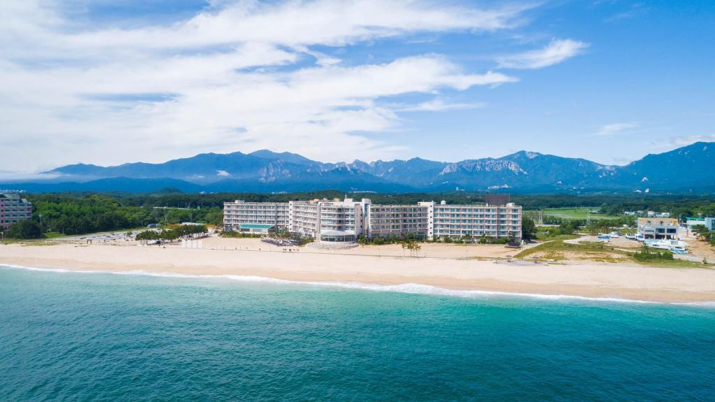 an aerial view of a beach with buildings and the ocean at Kensington Resort Seorak Beach in Sokcho