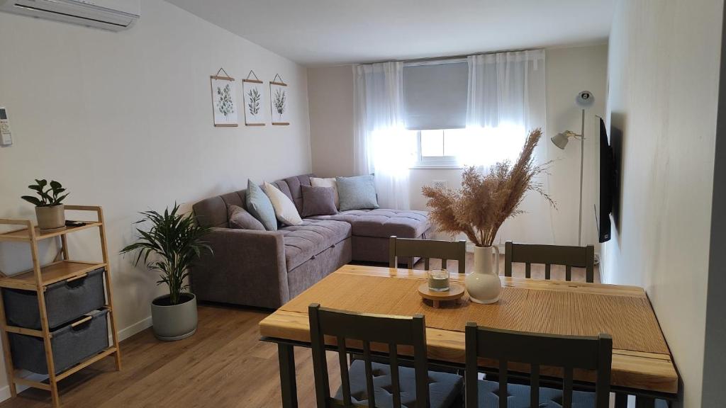 a living room with a table and a couch at פינה בנחלה in Ma'ale Gamla